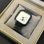 A Rado analog watch with a square black case, white dial, and black metal link bracelet, presented inside a beige cushioned watch box.